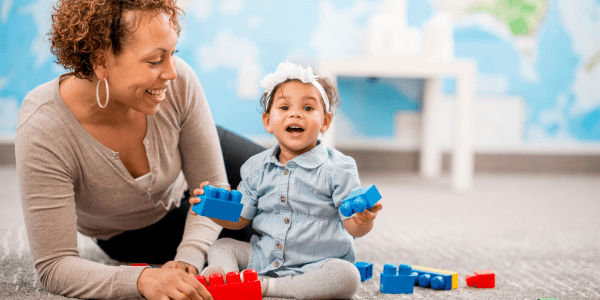 child care administrator and child playing at child care